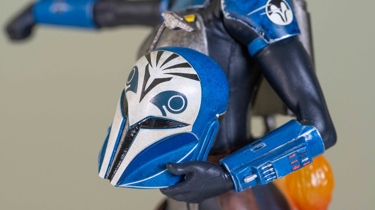 The helmet-under-the-arm attachment included with the Bo-Katan Kryze 1:7 scale statue on a green background