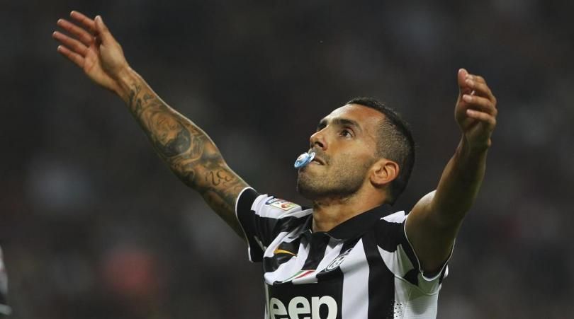 Carlos Tevez celebrates with a baby&#039;s dummy in his mouth after scoring for Juventus