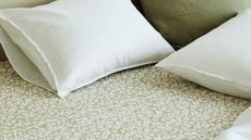 H&M Home botanical patterned fitted sheet in sage styled with white and coordinating sage pillows