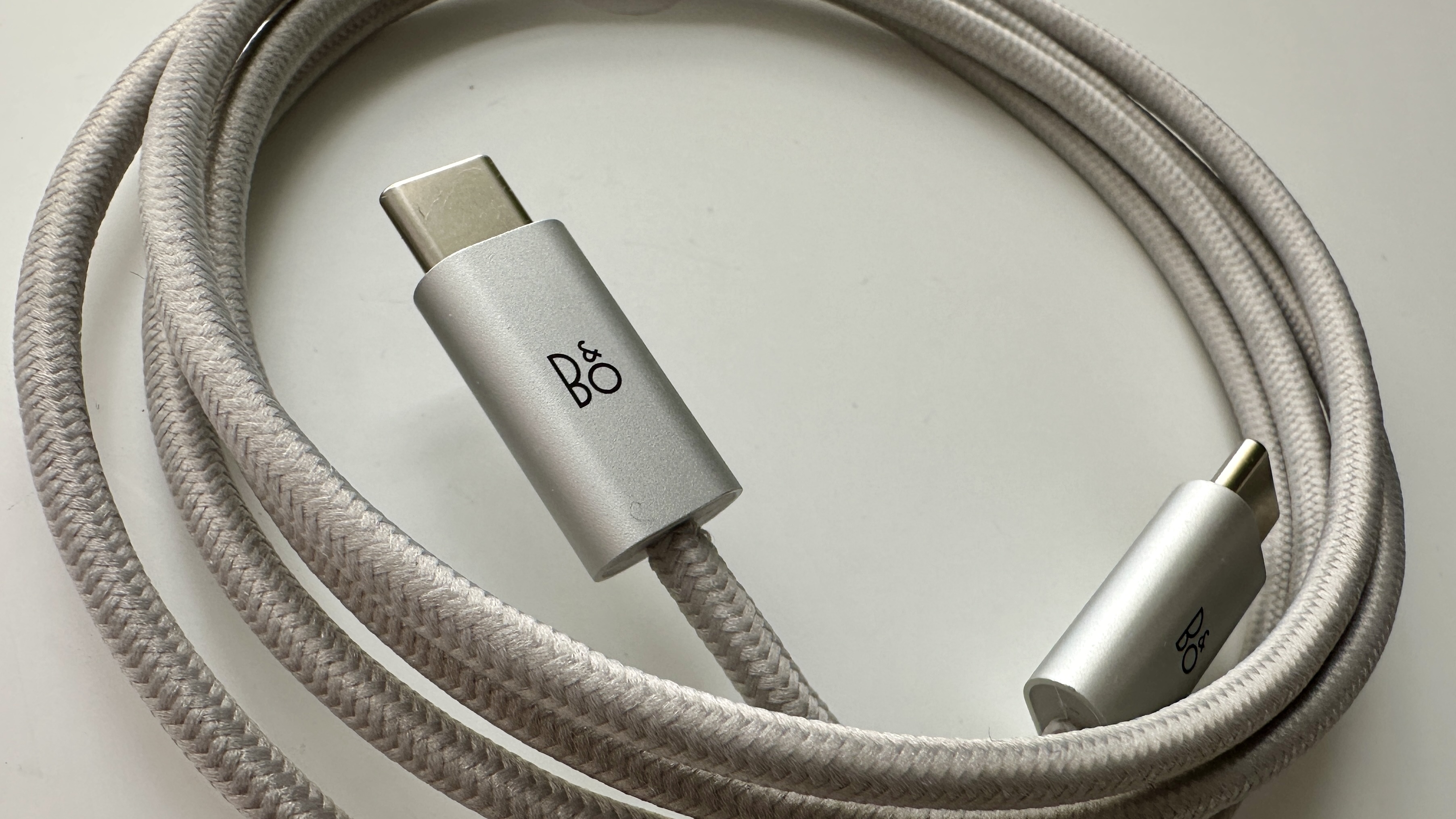 Bang & Olufsen Beosound A1 3rd Generation in silver, on gray table
