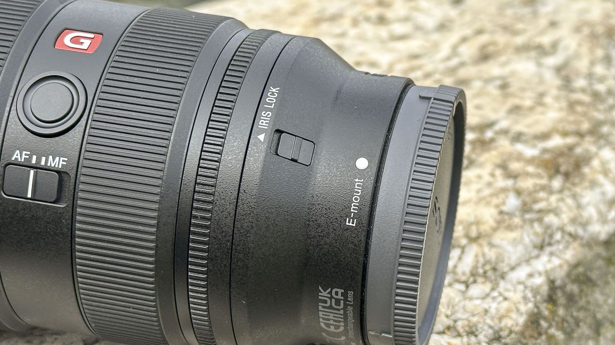 Closeup of Sony FE 16-35mm F2.8 GM II lens outdoors on a rock