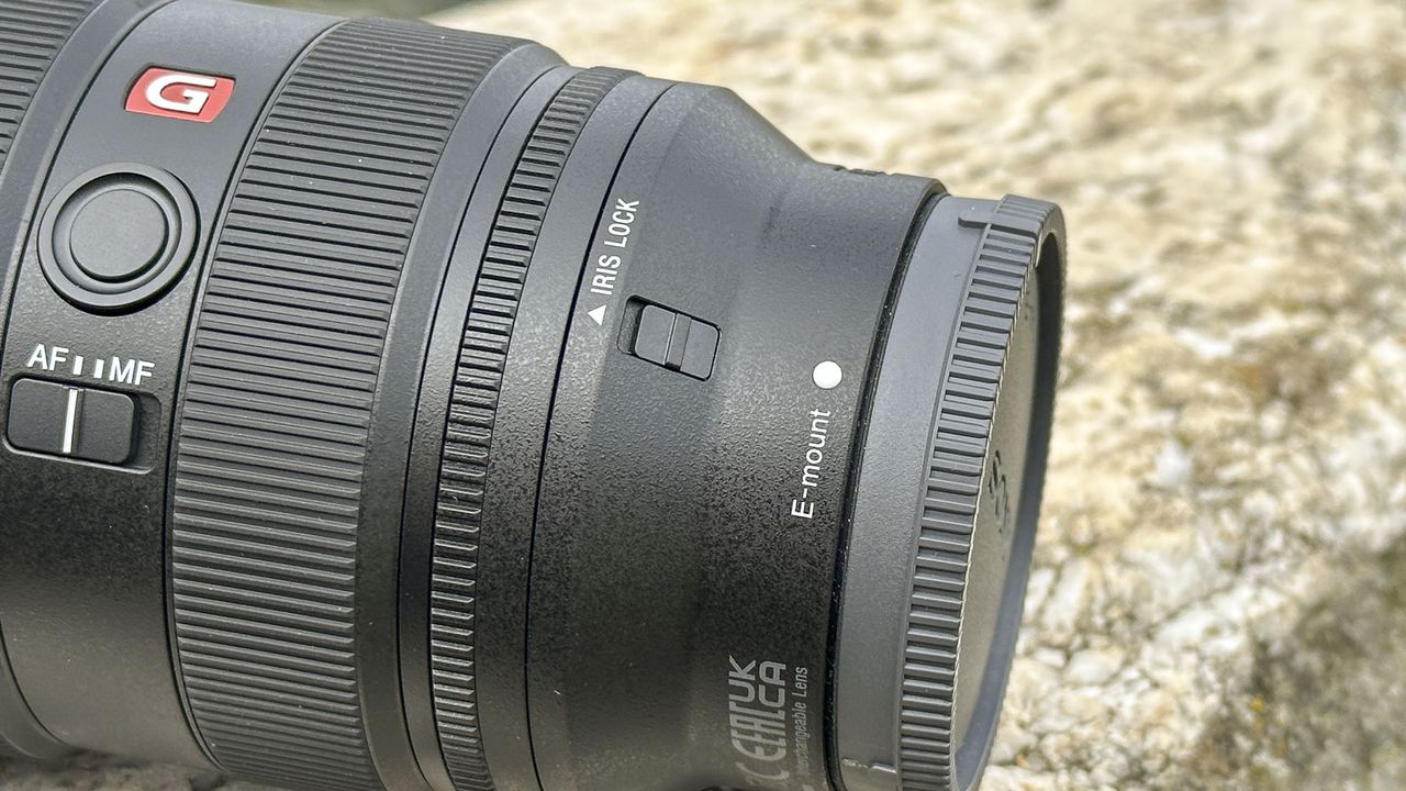 Closeup of Sony FE 16-35mm F2.8 GM II lens outdoors on a rock