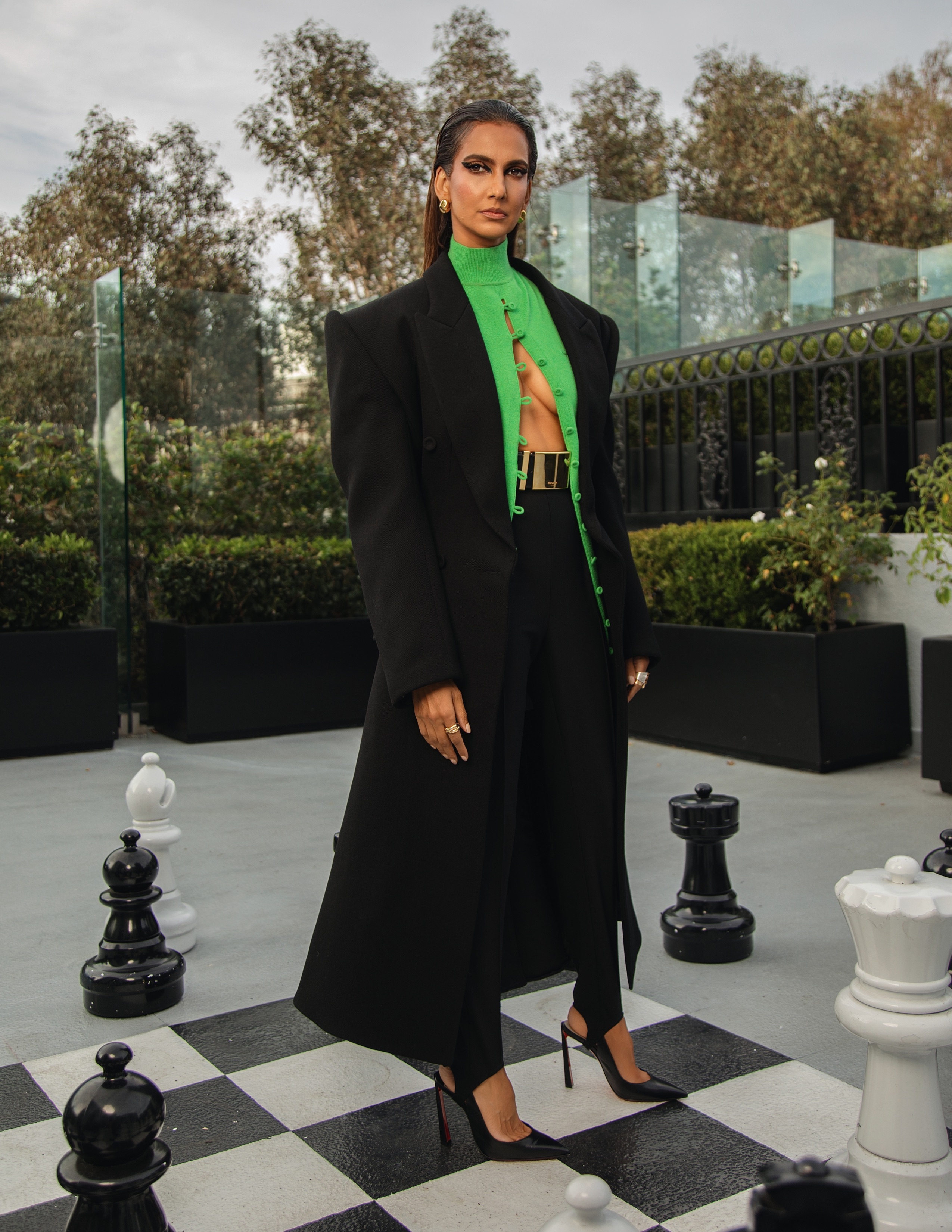 Poorna Jagannathan getting ready for the premiere of 'Lanterns' in L.A., wearing a black-and-green cool from Mugler.