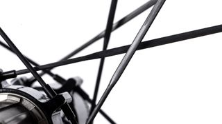 A black hub with black carbon spokes radiating from it sits against a a white background