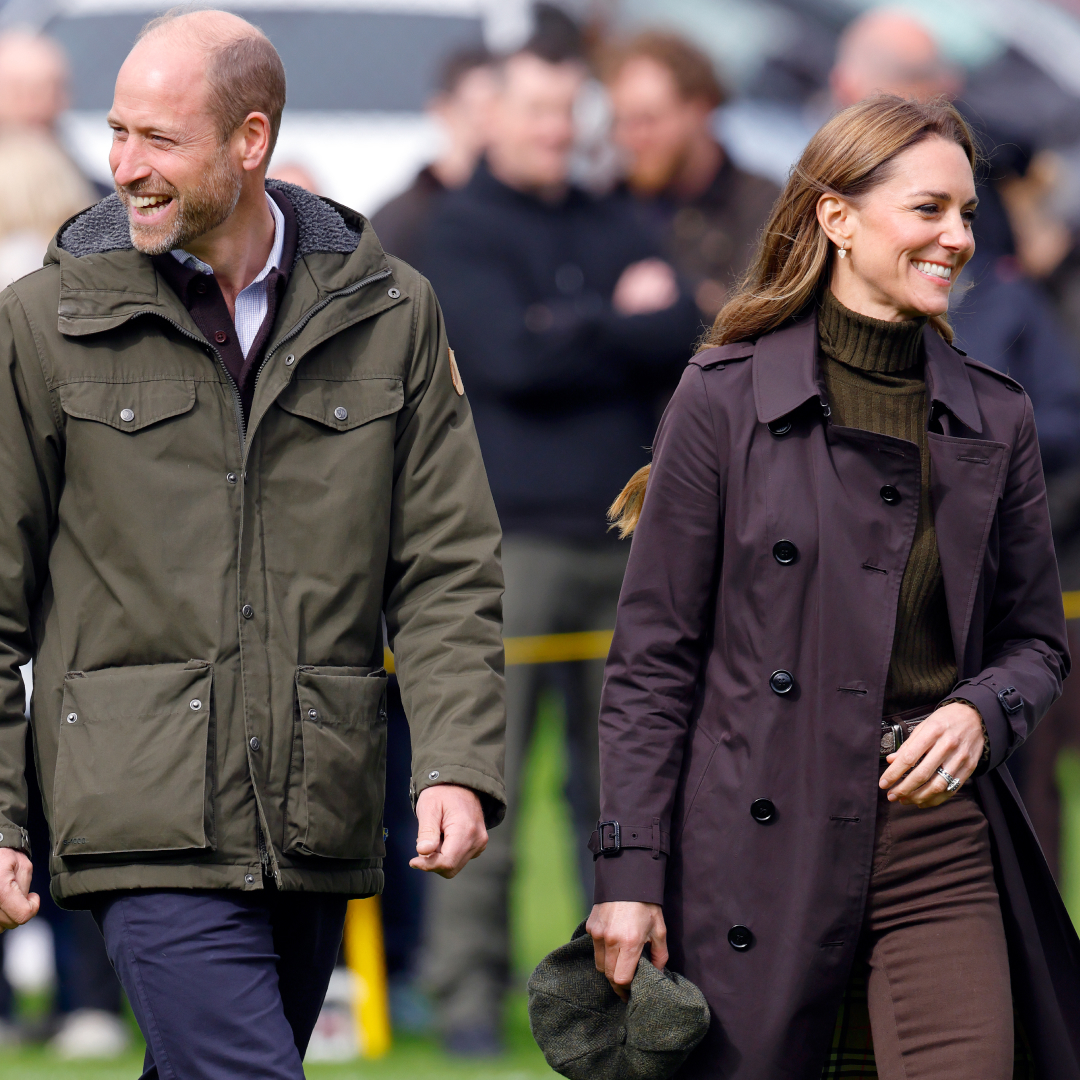 Prince William and Princess Kate walking next to each other and smiling in fall outfits