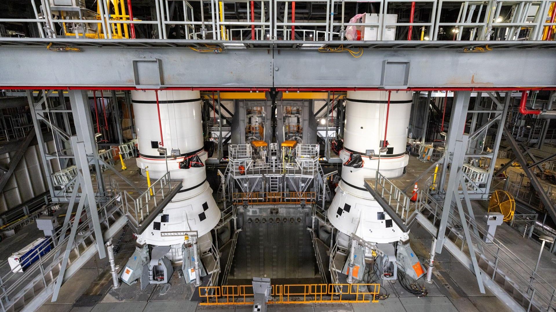 The left-hand and right-hand aft assembly solid rocket booster segments for NASA’s Artemis III SLS (Space Launch System) rocket are secured to the mobile launcher at the agency’s Vehicle Assembly Building at NASA’s Kennedy Space Center in Florida on July 11, 2026. 