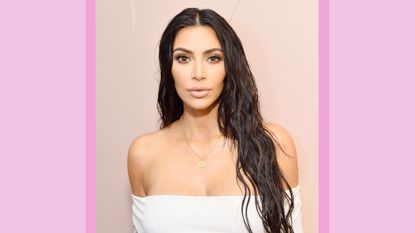 Kim Kardashian wears an off the shoulder white dress as she celebrates The Launch Of KKW Beauty on June 20, 2017 in Los Angeles, California/ in a purple template