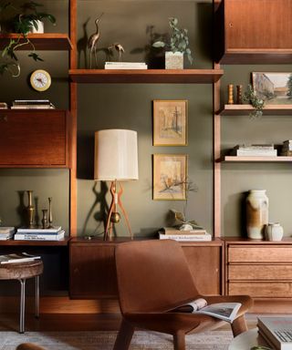 A mid-century modern library with brown chairs and floor-to-ceiling bookshelves