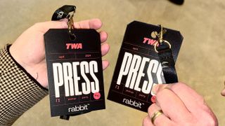 Press badges picked up at the Rabbit R1 pickup party