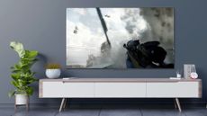 One of the best budget TVs, this is a TCL 5-Series Google TV (S546) hanging on wall