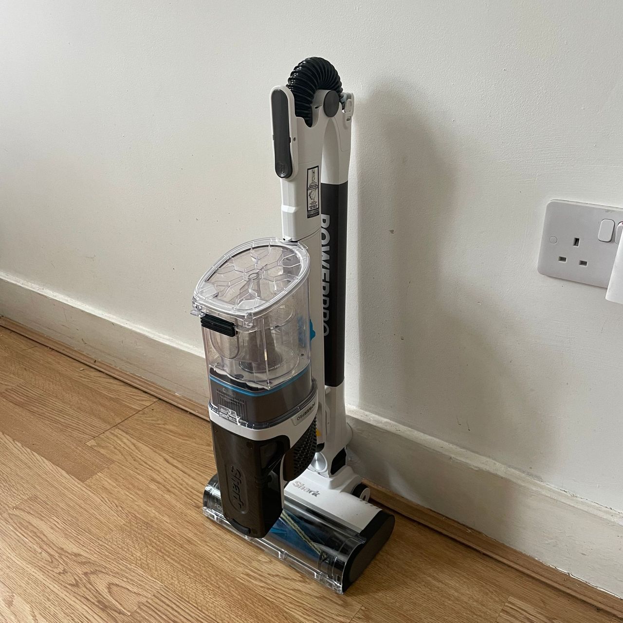 Shark PowerPro Pet Cordless Stick Vacuum folded down in front of a white wall