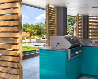 covered outdoor grill by CENA Outdoor Kitchens