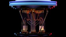 A photo of a quantum computer model, with intricate wiring and glass pipework on a black background.