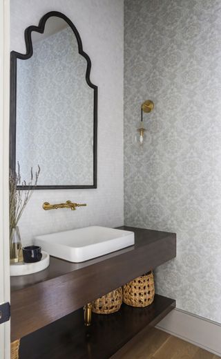 grey powder room with printed wallpaper by Brad Ramsey Interiors
