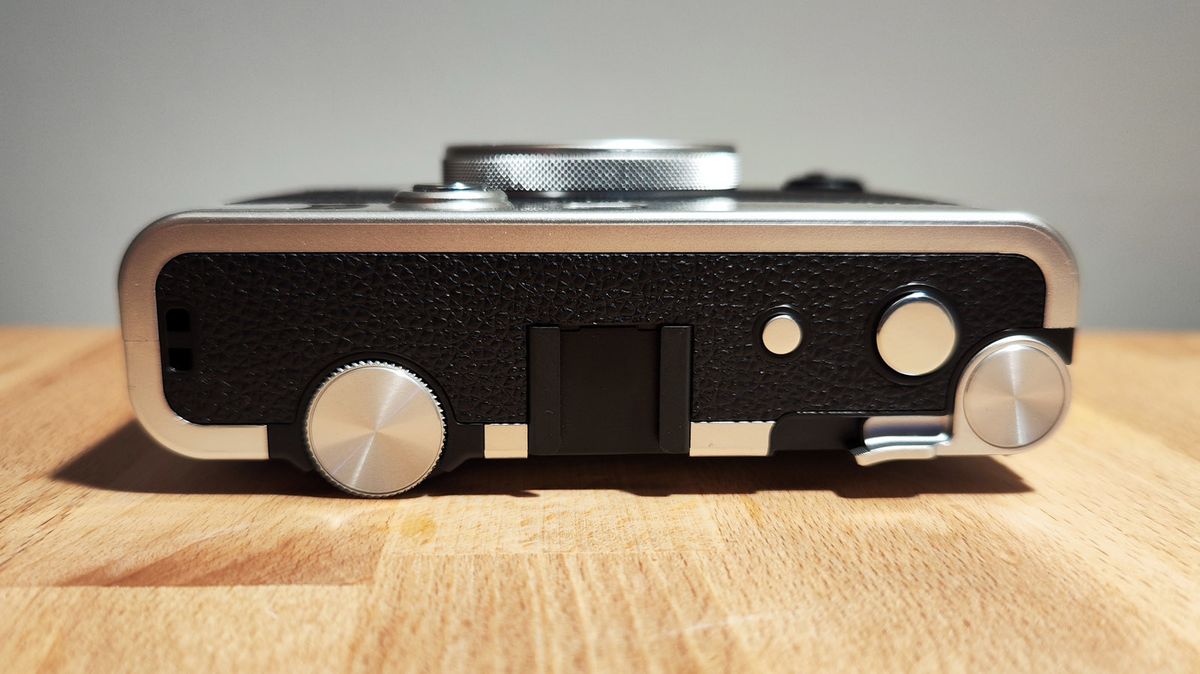The Fujifilm Instax Mini Evo on a wooden table