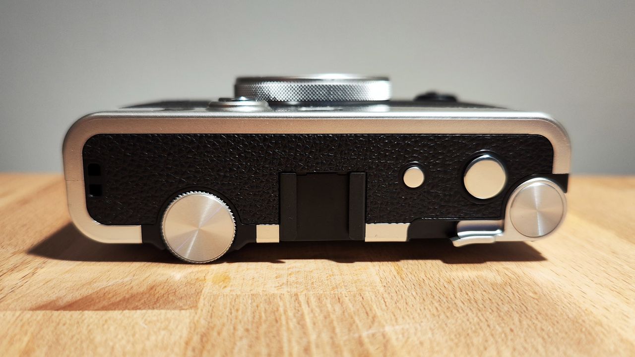 The Fujifilm Instax Mini Evo on a wooden table
