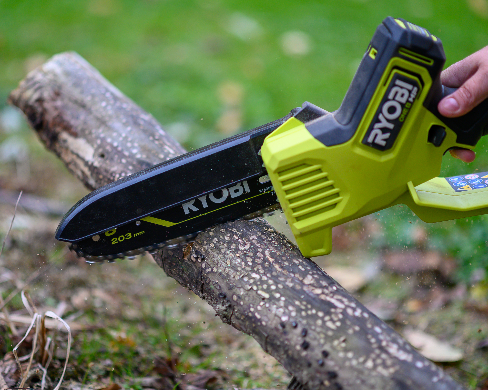 Ryobi chainsaw cutting a log