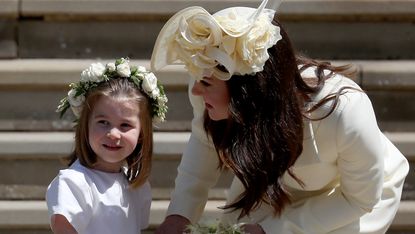 Princess Charlotte of Cambridge stands on the steps with her mother Catherine, Duchess of Cambridge after the wedding of Prince Harry and Ms. Meghan Markle at St George's Chapel at Windsor Castle on May 19, 2018 in Windsor, England