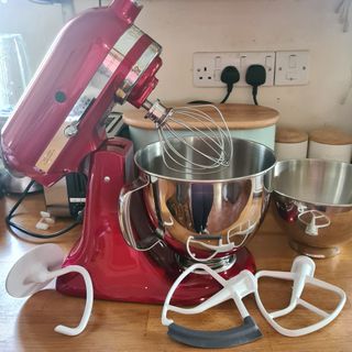 KitchenAid Artisan stand mixer and all parts on a kitchen worktop