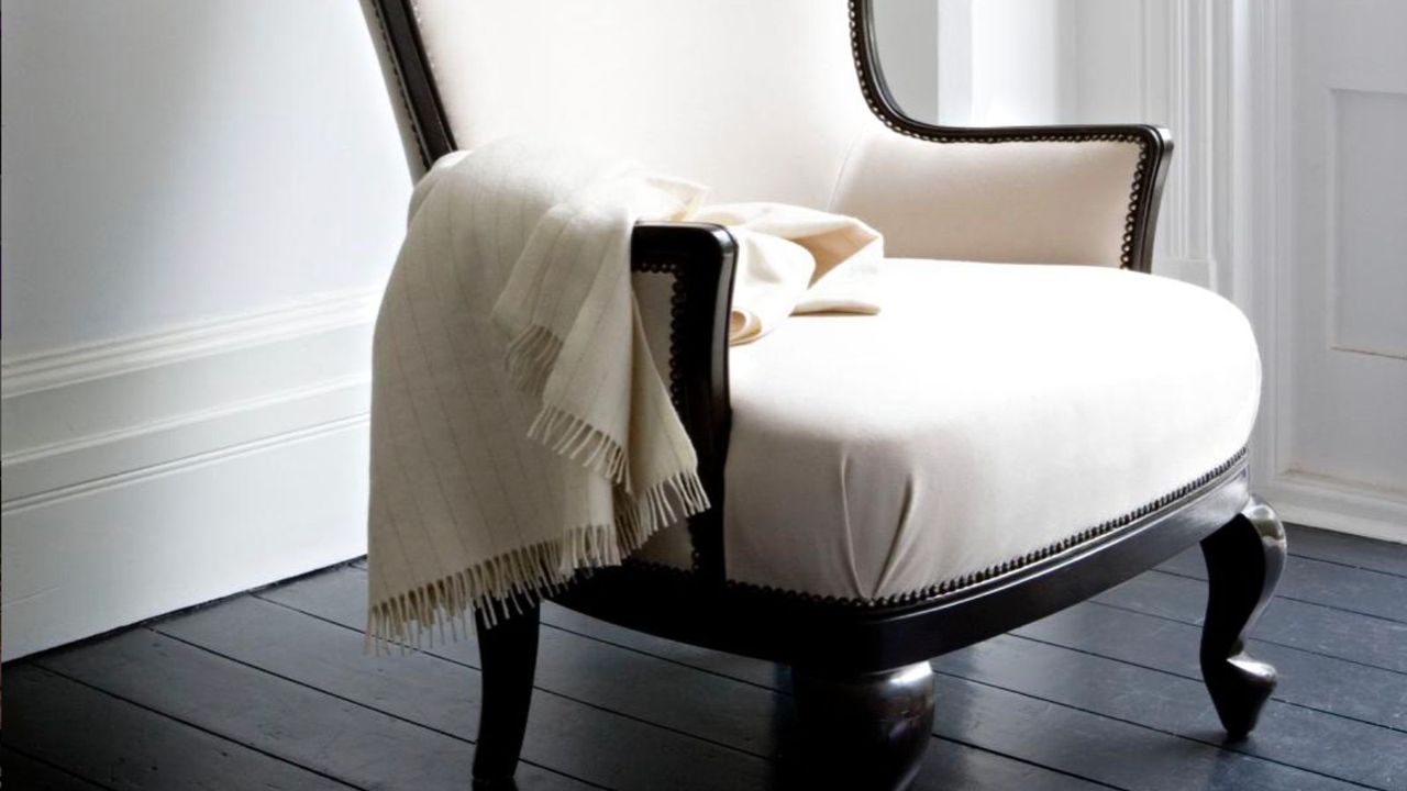 Studio chair covered in cream lambswool with cream cashmere throw 