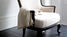Studio chair covered in cream lambswool with cream cashmere throw