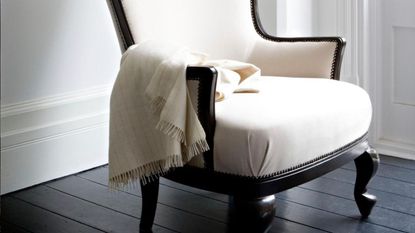 Studio chair covered in cream lambswool with cream cashmere throw 