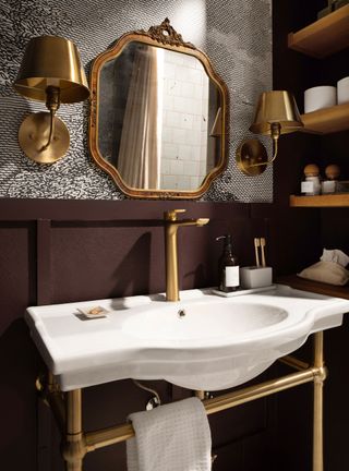 Modern powder room with gold fixtures and purple panel wall