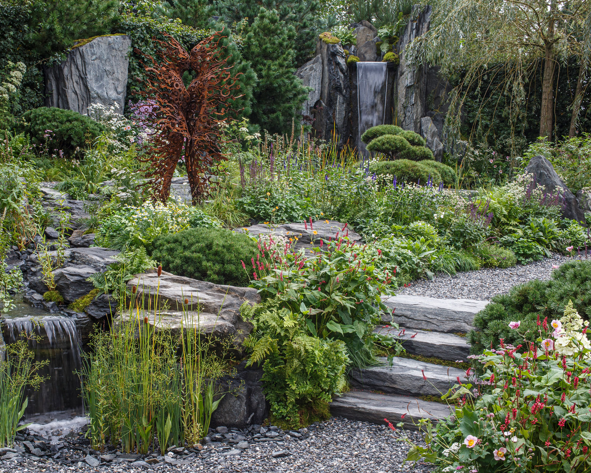 rock garden with gravel, planting, steps and sculpture