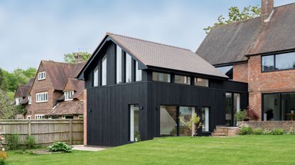 rebuilding an extension exterior of a property with a large extension covered in black timber cladding