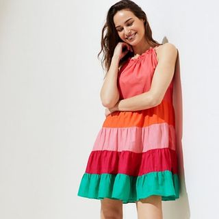 model wearing colorful striped beach dress