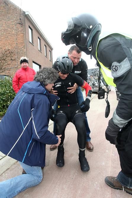 Boonen is helped to his feet after his crash in Gent-Wevelgem