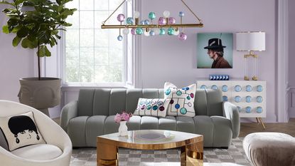Jonathan Adler designed lavender room with gray sofa and artwork