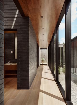 A hallway with dark and light wood