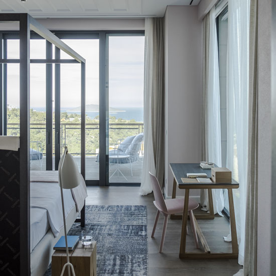bedroom with glass sliding windows and wooden flooring