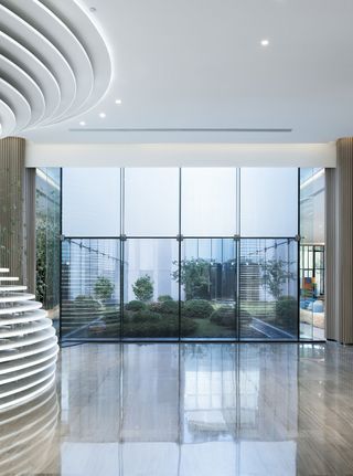 Lobby with large windows and white swirling pillars