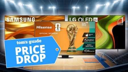 Three oversized TVs shown above a basketball stadium