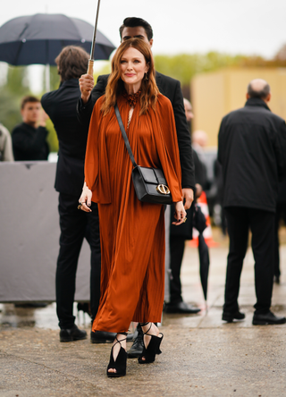 Julianne Moore wears a frilly collar rust-color pleated dress, a Dior bag, outside Dior during Paris Fashion Week - Womenswear Spring Summer 2020, on September 24, 2019 in Paris, France