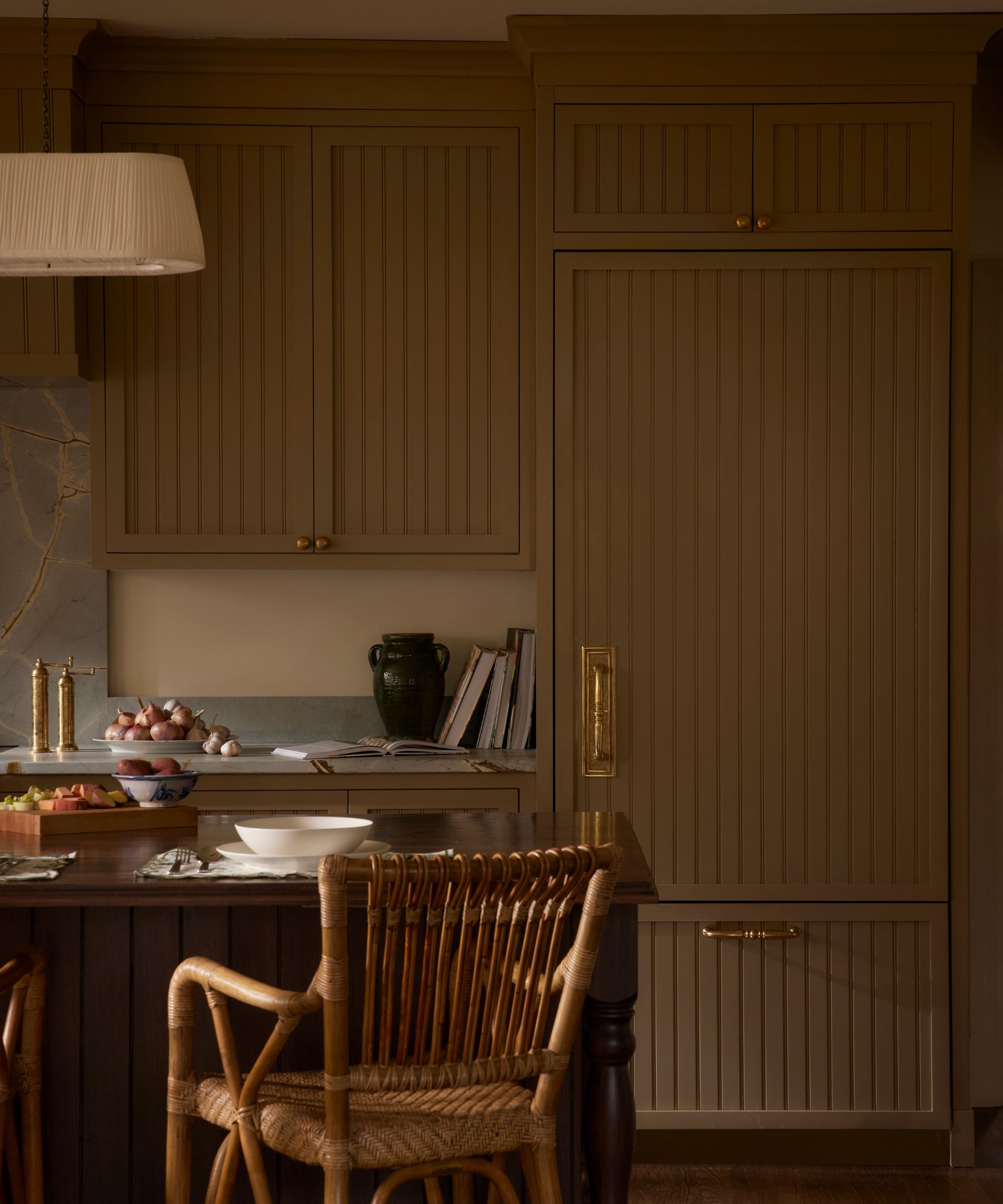 A warm neutral kitchen with slatted cabinets and blue stone countertops