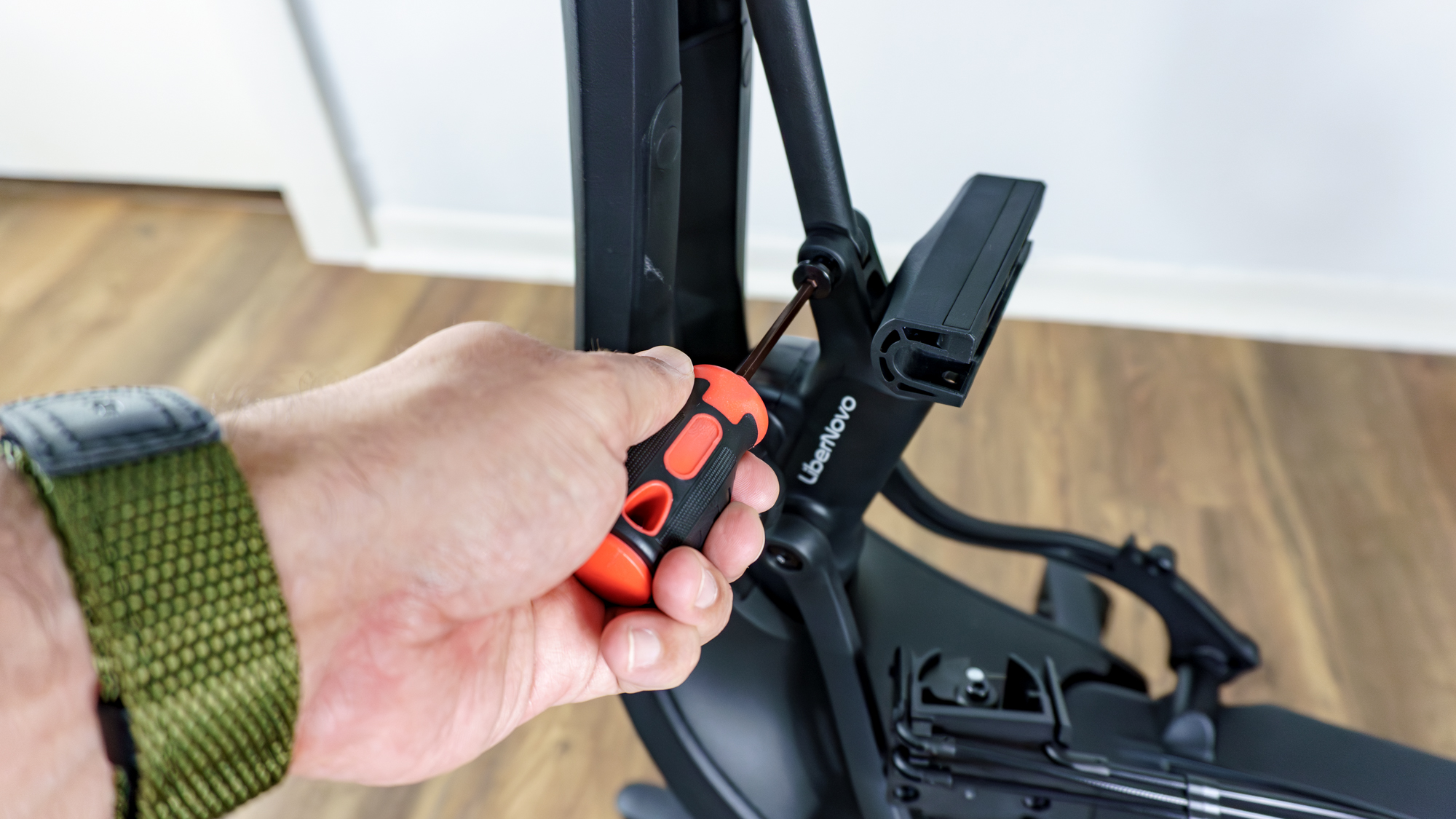 A person using the included hardware to assemble the LiberNovo Omni SE office chair