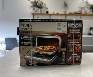 The Ninja Woodfire Outdoor Oven in its box in the text kitchen