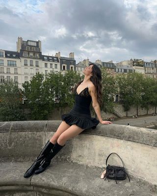 Content creator Sarah Sol posing by the River Seine