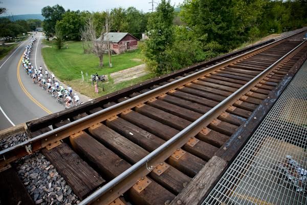 The bunch passes under train tracks along the route.