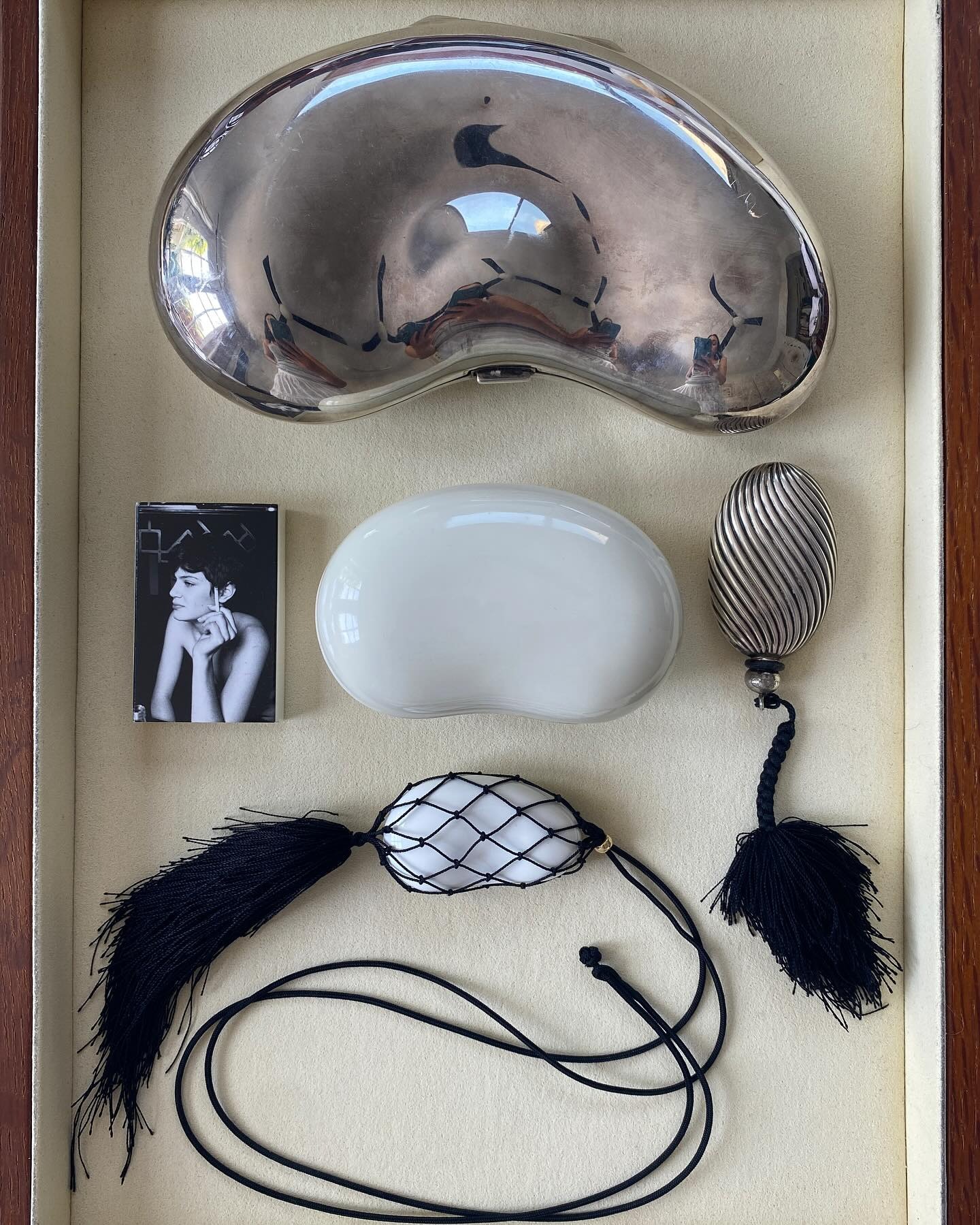 A bunch of objects including tassel necklaces and tassel decorative objects.