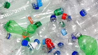 Discarded used water bottles in recycling bin