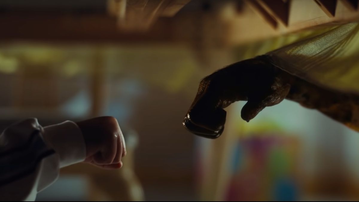 An alien fist bumping in Nope