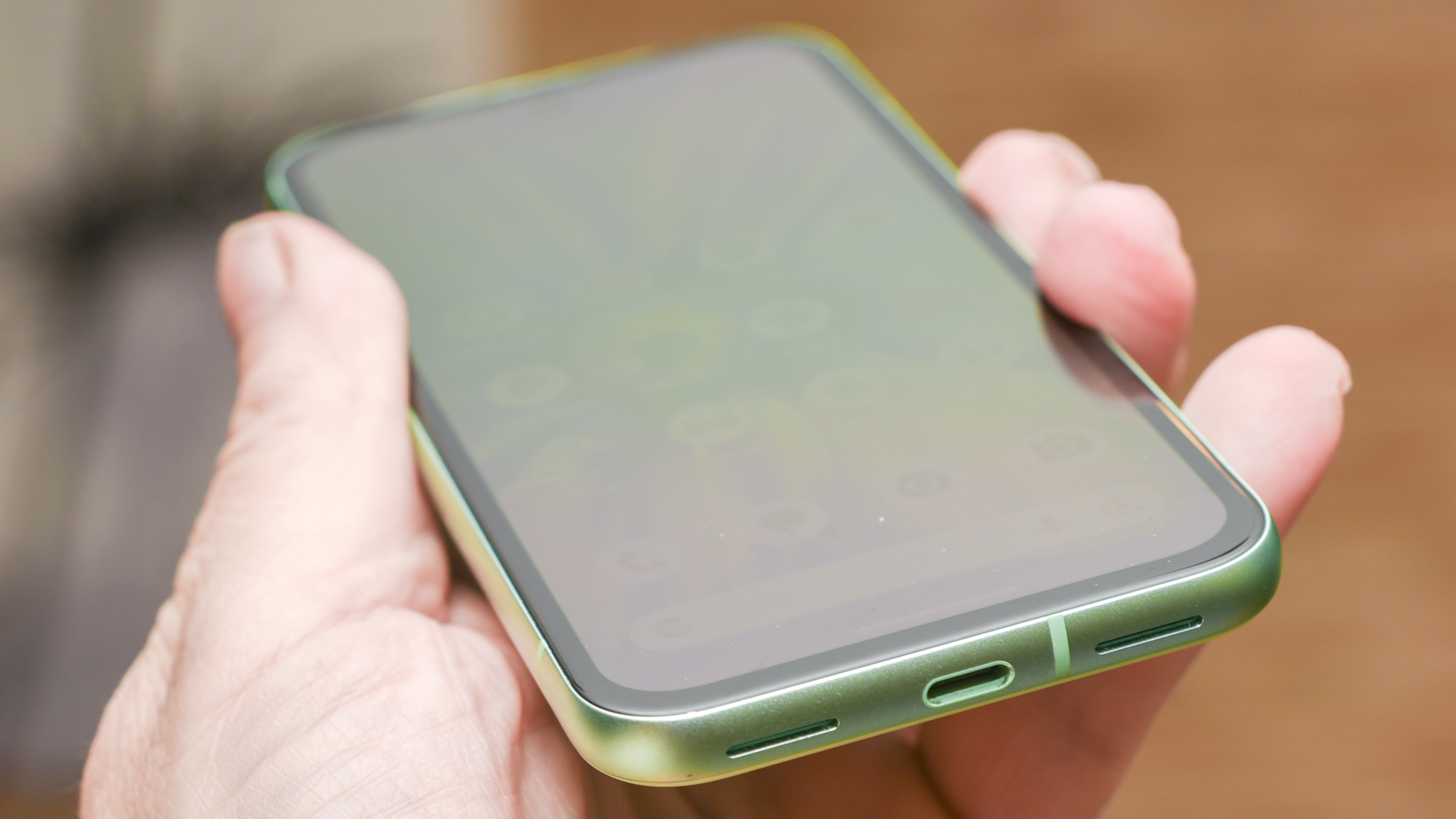 Google Pixel 8a in aloe green showing USB-C port and speakers