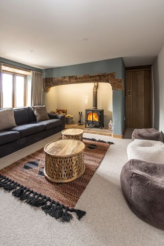 modern living room with rustic inglenook fireplace painted blue