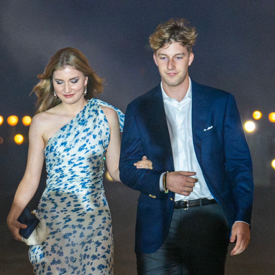 Princess Elisabeth wearing a white gown walking with Prince Emmanuel