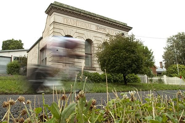 A rider speeds past an old bank in Learmonth just after his start in the mens under 23 time trial championship.