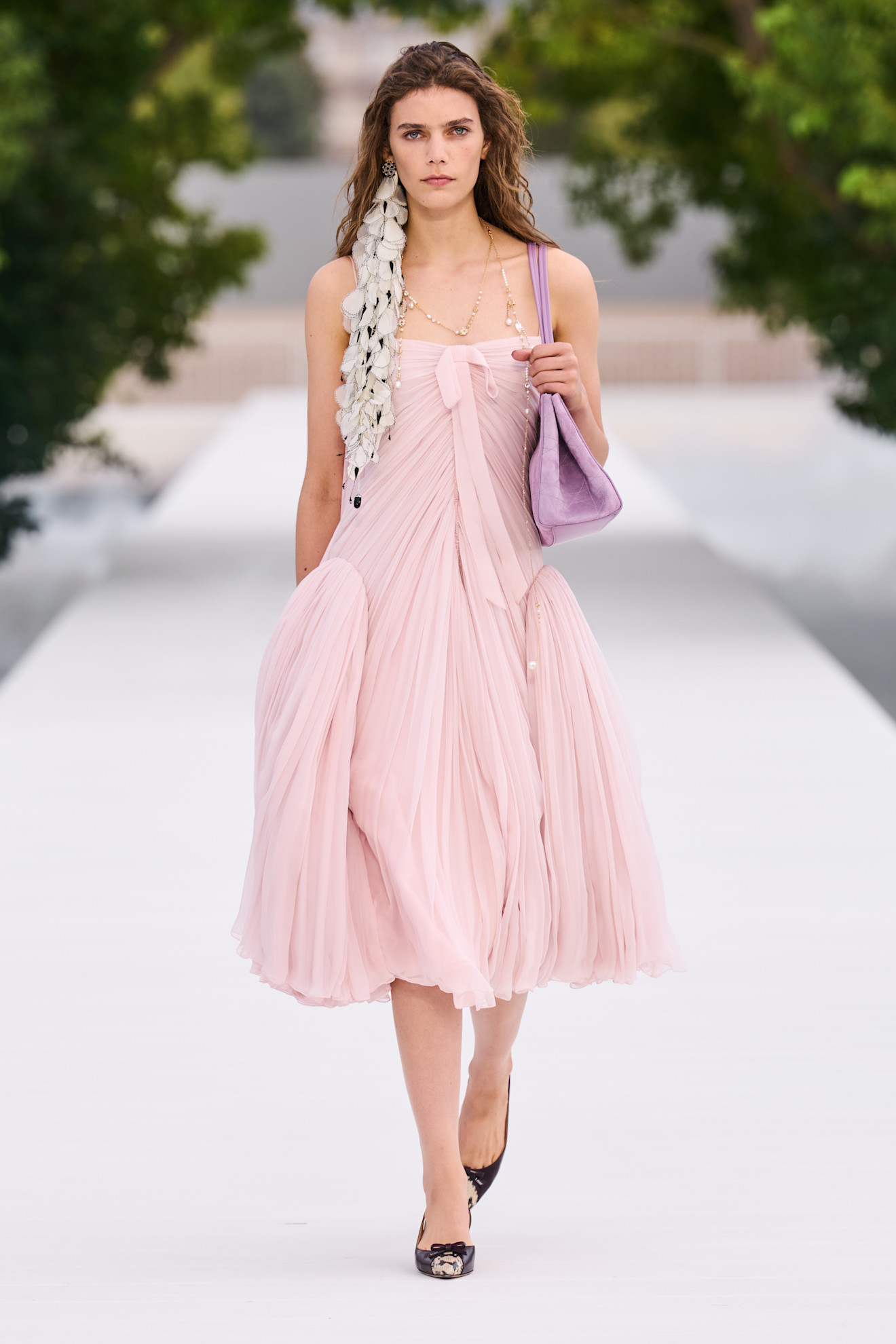 a woman wears a peplum dress at dior spring 2027.
